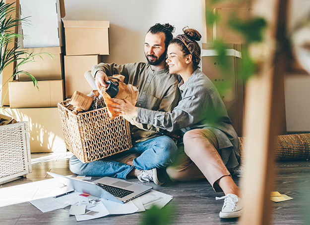 A couple unpacking boxes in their new home.